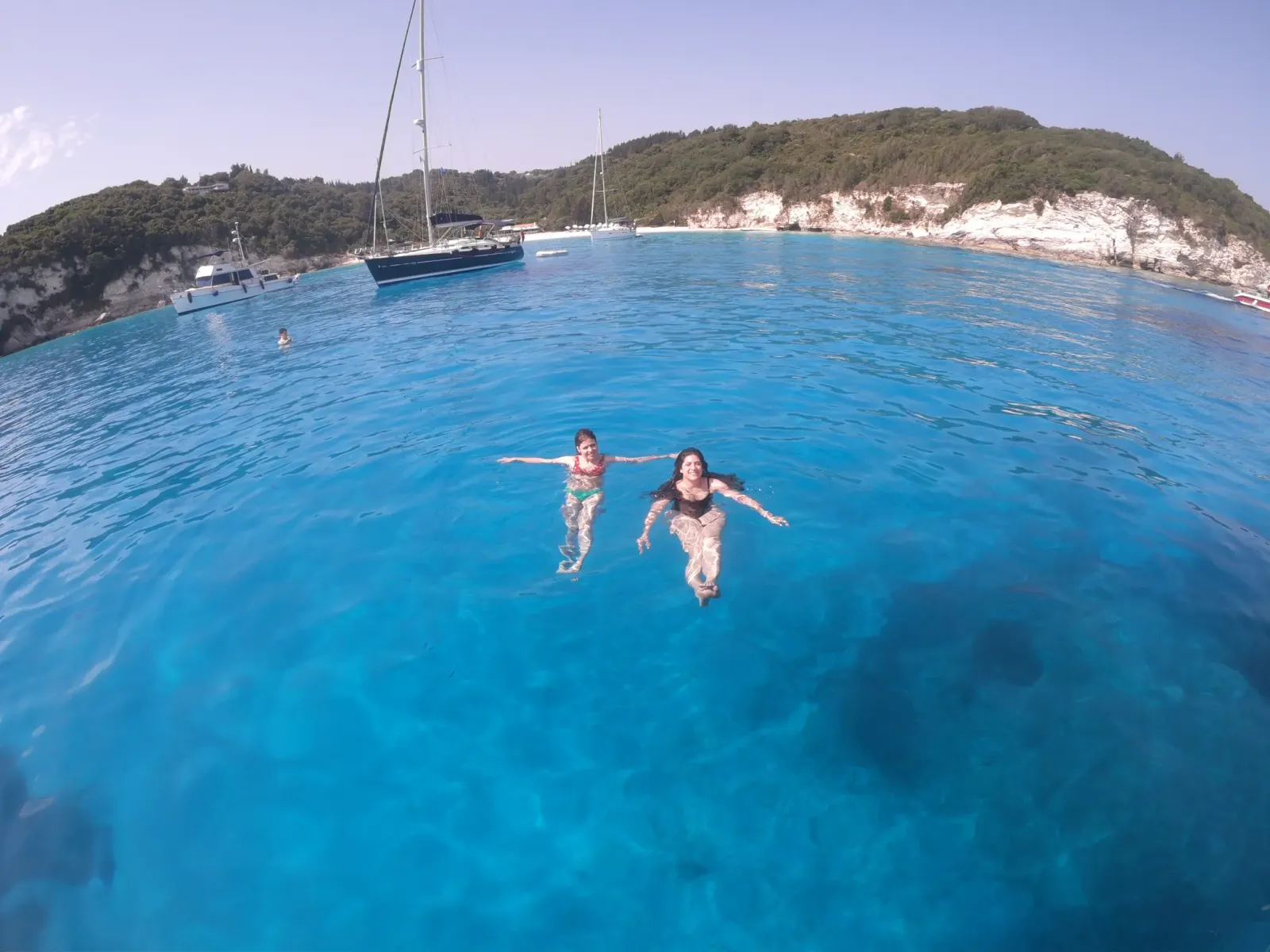 girls swimming in turquoise waters on a yacht4less sailing holiday