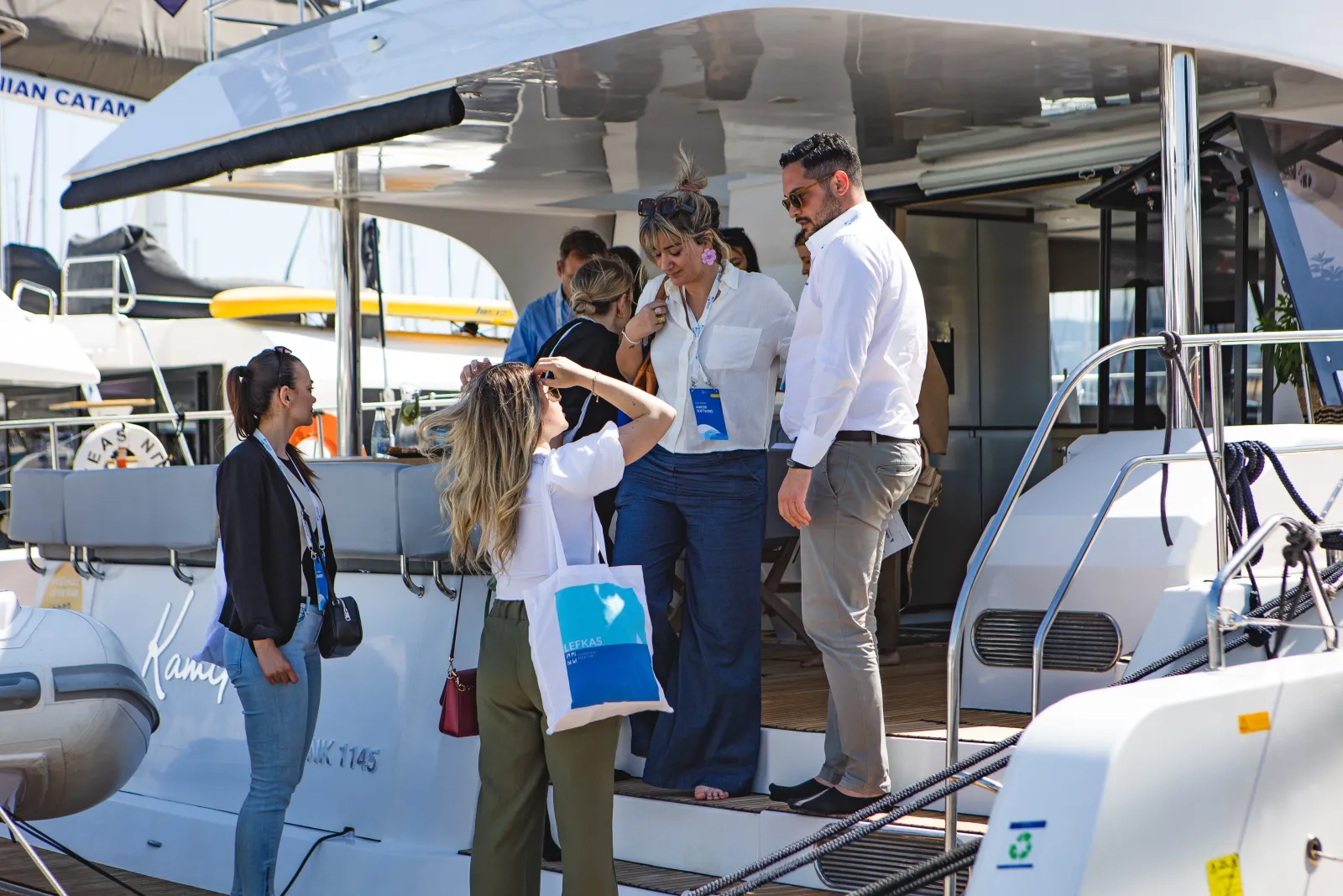 Yacht4Less company representatives discussing onboard an Aventura 50 in the Ionian Islands, during the Charter Meetup expo.
